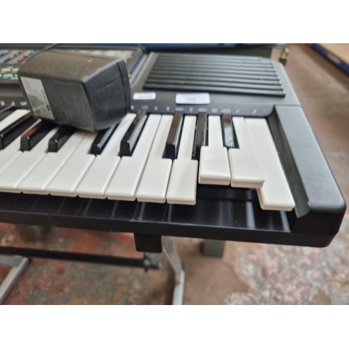 543 - A Casio CT-636 electronic keyboard with stand and power adaptor