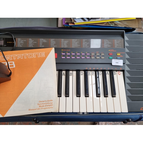 544 - A Yamaha PSR-28 electronic keyboard with stand, power adaptor and a collection of books