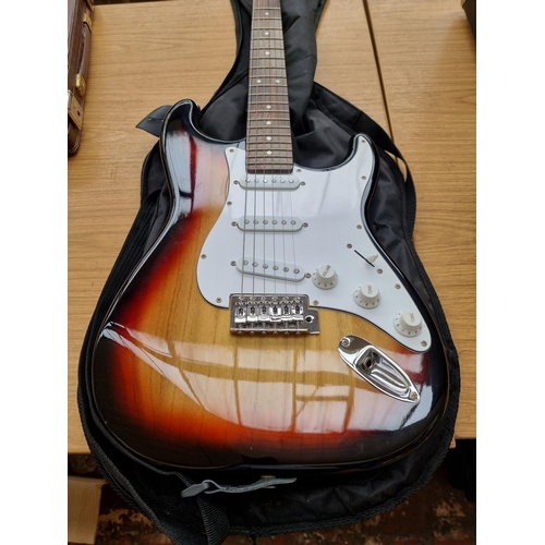 549 - A cased Crafter Cruiser sunburst Stratocaster style electric guitar with strap, pitch pipe and tremo... 