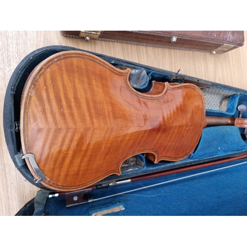 550 - A cased vintage ¾ size violin with bow