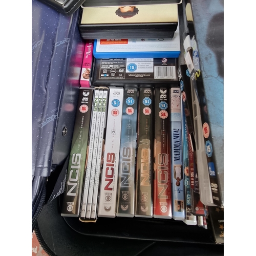 551 - A suitcase containing a large collection of DVDs