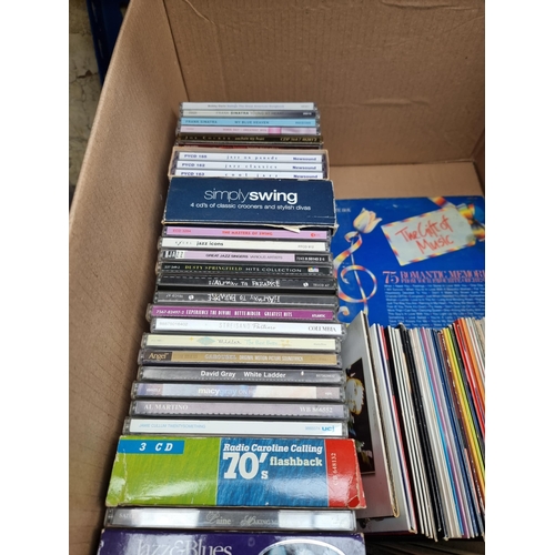 553 - A box and two storage units containing CDs, sealed blank cassettes and cassettes to include Pink Flo... 