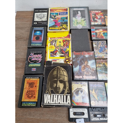 560 - A large collection of Sinclair ZX Spectrum game cassettes to include Alien 8, Sabre Wulf, Knight Lor... 