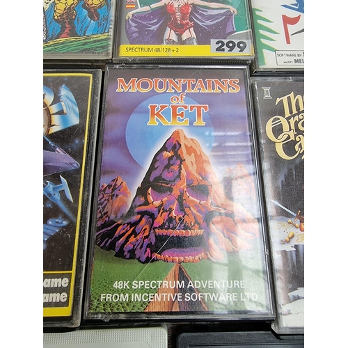 560 - A large collection of Sinclair ZX Spectrum game cassettes to include Alien 8, Sabre Wulf, Knight Lor... 