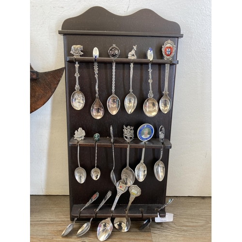 313 - A large collection of white metal collector's spoons and four hardwood wall mountable display plaque... 