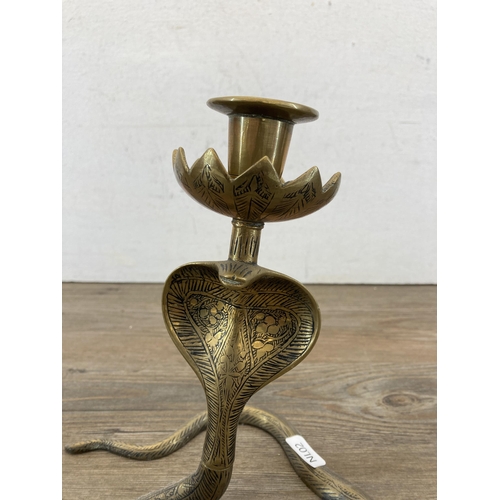 317 - A pair of Middle Eastern brass cobra candlesticks