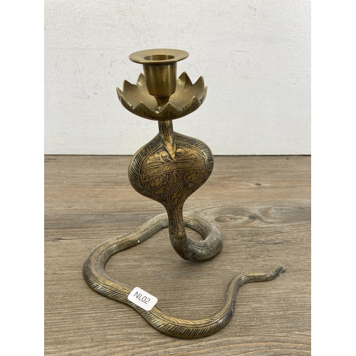 317 - A pair of Middle Eastern brass cobra candlesticks