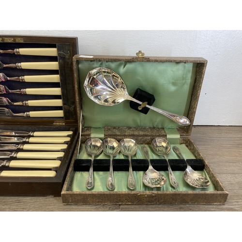 323 - Five vintage cased items, four silver plated cutlery sets and one set of brass Trent Scales