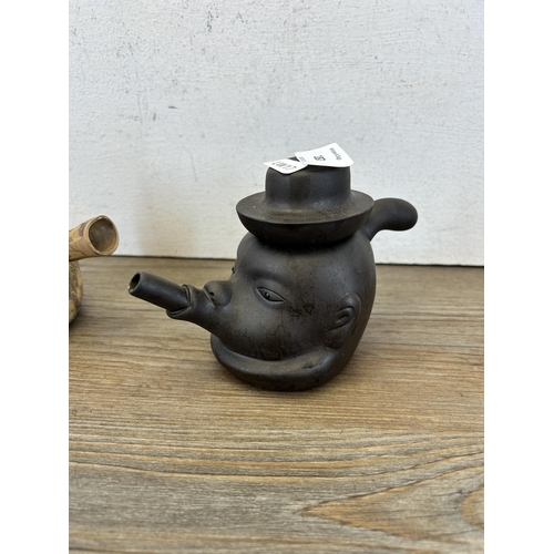 187 - Two Chinese clay teapots to include Yixing face teapot etc. - largest approx. 10cm high