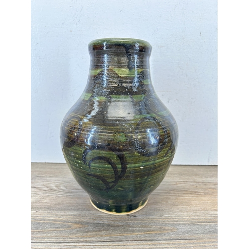 195 - A mid 20th century green glazed studio pottery vase marked 'BA' to base - approx. 27cm high