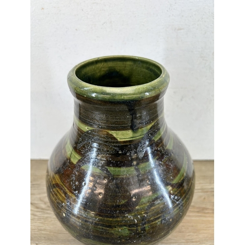 195 - A mid 20th century green glazed studio pottery vase marked 'BA' to base - approx. 27cm high