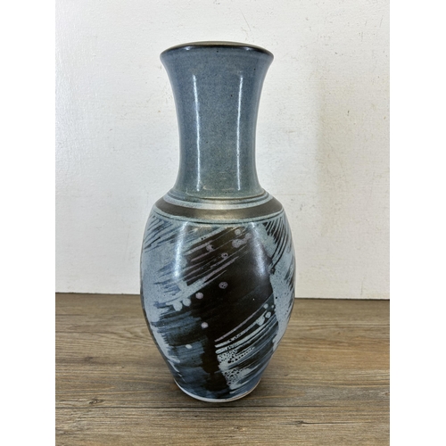 196 - A mid 20th century blue glazed studio pottery vase marked 'RC' to base - approx. 36cm high