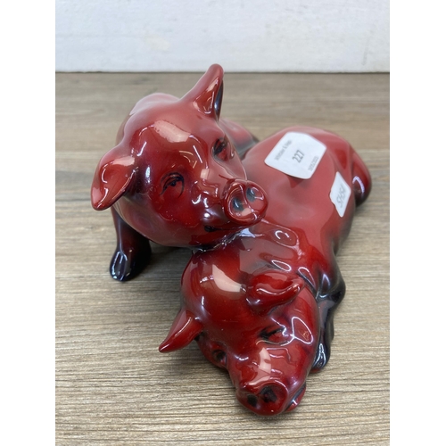 227 - A Royal Doulton Flambé Snoozing Pigs figurine signed 'Noke' - approx. 18cm long