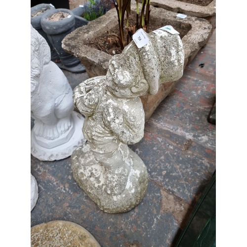 714 - A cast stone garden ornament in the form of a man with top hat