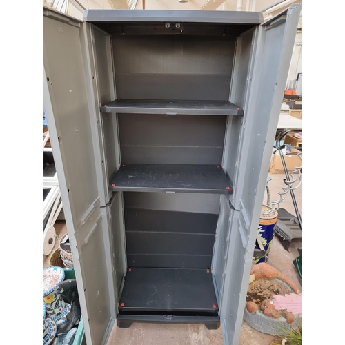 725 - A plastic shed storage unit with double door and internal shelves - approx. 173cm high x 69cm wide x... 