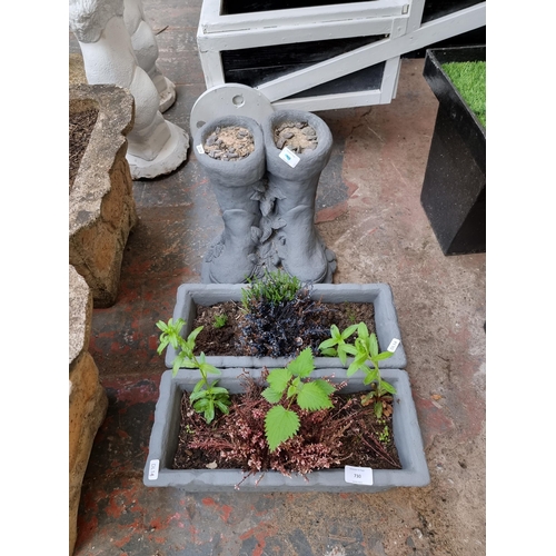 730 - Three grey painted cast stone planters, two rectangular and one pair of wellington boots