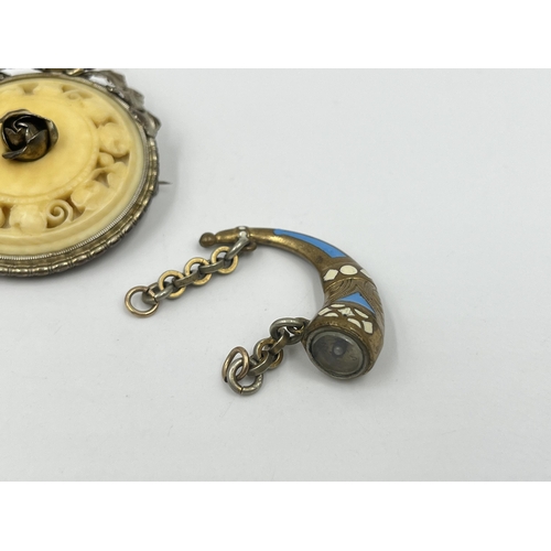 1192 - Five antique and vintage brooches to include novelty horn compass, ivory effect circular floral stam... 