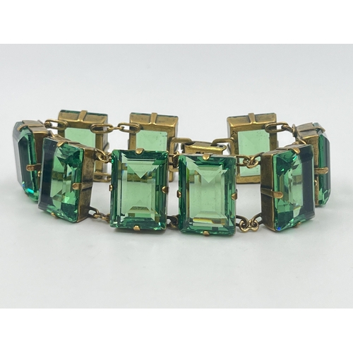 1193 - An Art Deco style Sarah Booth green paste and brass three piece jewellery set