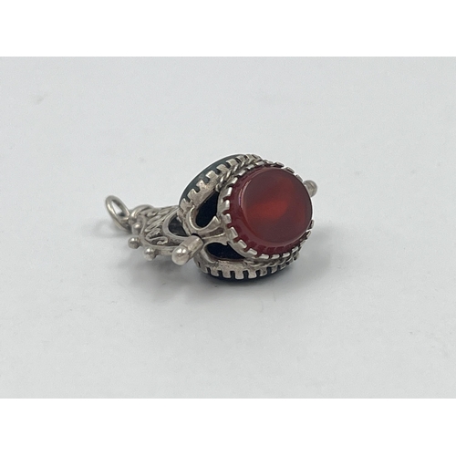 1212 - An antique white metal bloodstone, carnelian and black onyx spinner fob