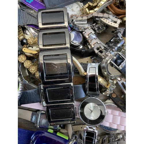 397 - A large collection of wristwatches to include Michael Kors, Taylor Cole, Swatch etc.