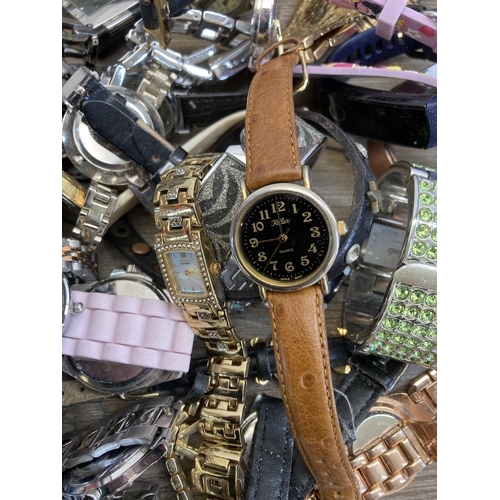 397 - A large collection of wristwatches to include Michael Kors, Taylor Cole, Swatch etc.