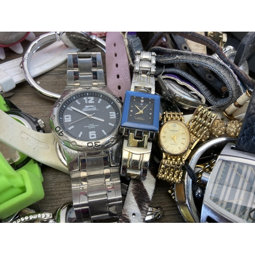 397 - A large collection of wristwatches to include Michael Kors, Taylor Cole, Swatch etc.