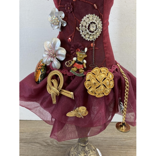 408 - A mannequin with seventeen vintage brooches