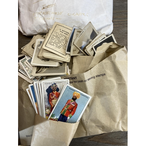 412 - A collection of vintage cigarette cards to include Ogden's Cigarettes, W. D & H. O. Wills etc.