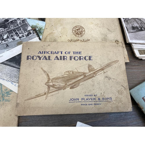 413 - A collection of vintage post and cigarette cards to include John Player & Sons Aircraft of The Royal... 