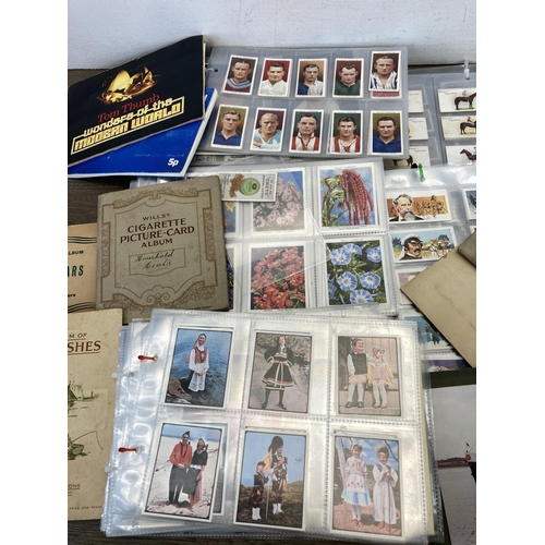 414 - A collection of vintage post, cigarette and picture cards to include Brooke Bond Adventurers and Exp... 