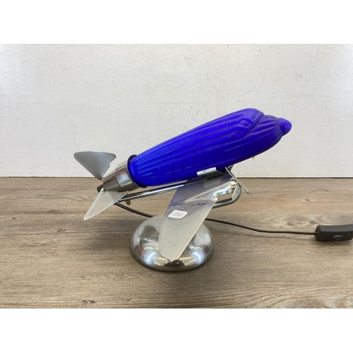 426 - A mid 20th century chrome plated and blue glass table lamp in the form of a propellor plane