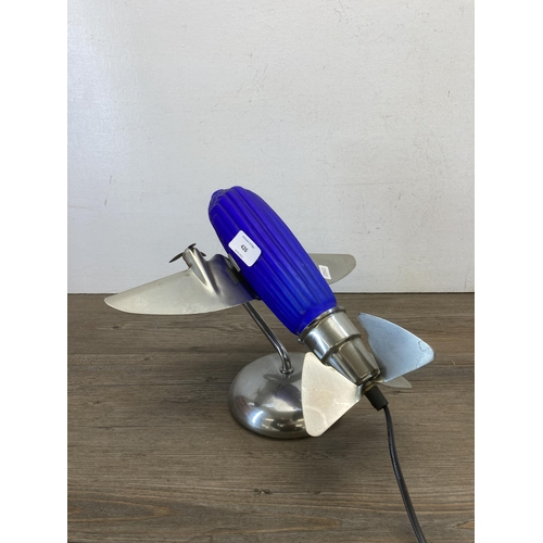 426 - A mid 20th century chrome plated and blue glass table lamp in the form of a propellor plane