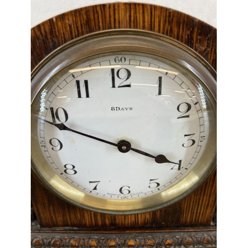 450 - An early 20th century French Bayard mantel clock with carved oak case