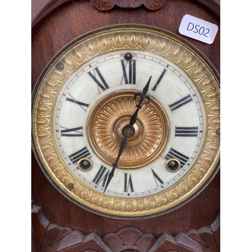 454 - An early 20th century Ansonia Clock Co. New York carved oak cased chiming mantel clock with enamel d... 