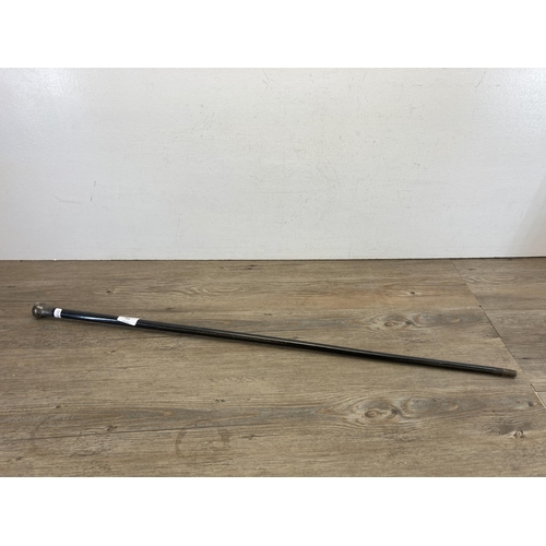 459 - A late 19th century black lacquered walking cane with white metal top - approx. 91cm long