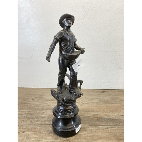 471 - Two spelter figurines in the form of a man and woman working the fields on wooden plinths - approx. ... 