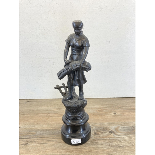 471 - Two spelter figurines in the form of a man and woman working the fields on wooden plinths - approx. ... 