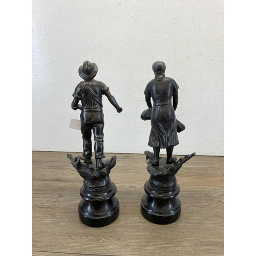 471 - Two spelter figurines in the form of a man and woman working the fields on wooden plinths - approx. ... 