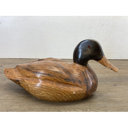 473 - Two carved hardwood duck sculptures - largest approx. 14cm high x 27cm long