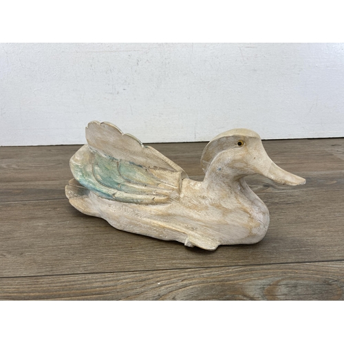 473 - Two carved hardwood duck sculptures - largest approx. 14cm high x 27cm long