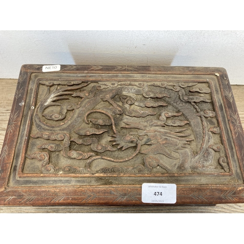 474 - A late 19th/early 20th century Oriental carved oak rectangular storage box with dragon scene to lid ... 