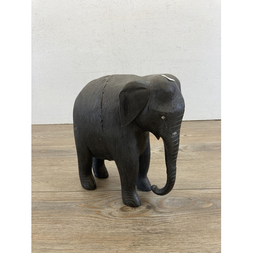 477 - A late 19th/early 20th century carved and ebonized elephant figurine - approx. 23cm high x 21cm long