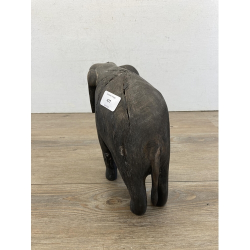 477 - A late 19th/early 20th century carved and ebonized elephant figurine - approx. 23cm high x 21cm long