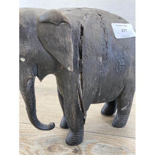 477 - A late 19th/early 20th century carved and ebonized elephant figurine - approx. 23cm high x 21cm long