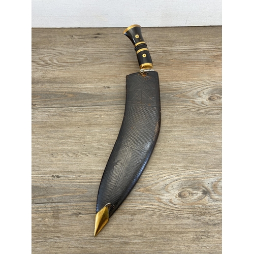 480 - A mid 20th century kukri knife with leather sheath and pair of miniatures