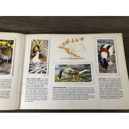 414A - Fourteen vintage collector's card albums, twelve Brooke Bond and two C.F. Tunnicliffe