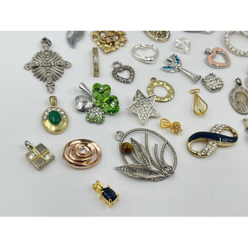 1231E - A collection of pendants and charms