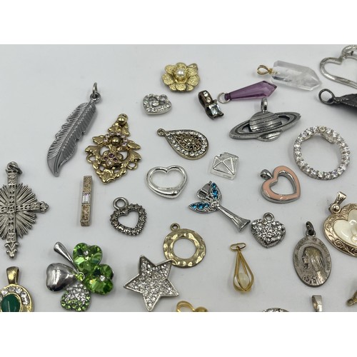 1231E - A collection of pendants and charms