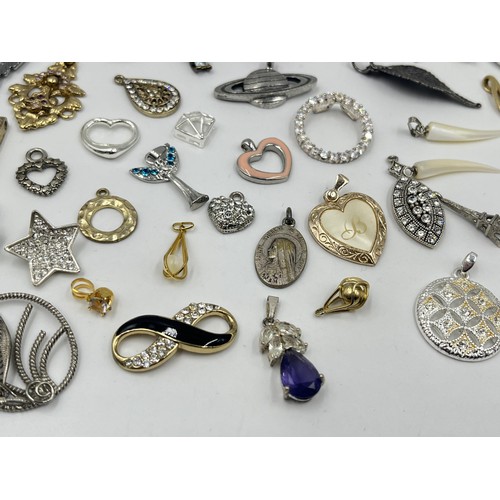 1231E - A collection of pendants and charms