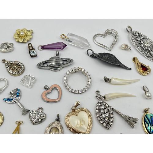 1231E - A collection of pendants and charms